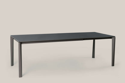 Tavolo Ingenia Prisma allungabile in metallo laccato, superficie liscia e design moderno, con estensione visibile.